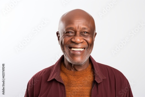Portrait of a senior man smiling at the camera on white background