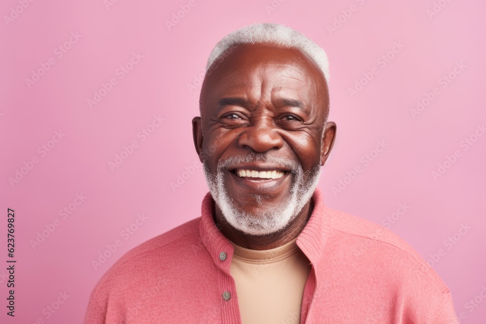 Portrait of happy african american senior man smiling and looking at camera isolated over pink background Portrait of happy african american senior man smiling and looking at camera isolated over pink background