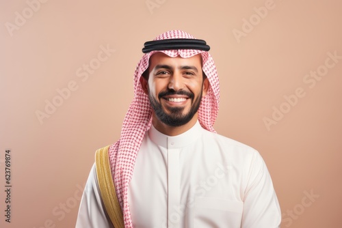 Portrait of a smiling arabian man on a pink background