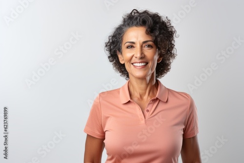Portrait of happy mature woman with curly hair, isolated on white background