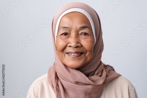 Portrait of a senior muslim woman with hijab smiling at camera