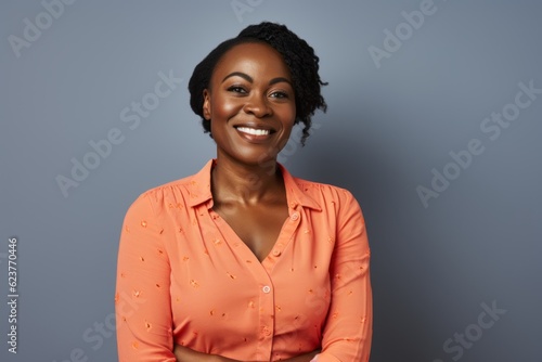 Portrait of a smiling african american businesswoman standing against grey background