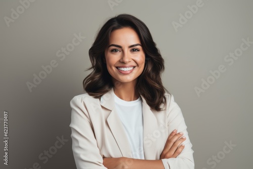 Portrait photography of a happy Saudi Arabian woman in her 30s wearing a chic cardigan against a minimalist or empty room background 