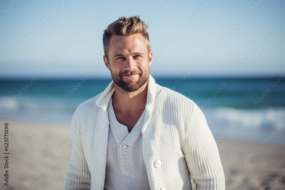 Portrait of handsome man standing on the beach on a sunny day Portrait of handsome man standing on the beach on a sunny day