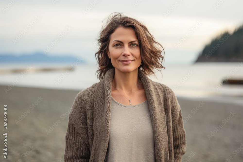 Portrait photography of a happy Russian woman in her 40s wearing a chic cardigan against a beach background Portrait photography of a happy Russian woman in her 40s wearing a chic cardigan against a beach background