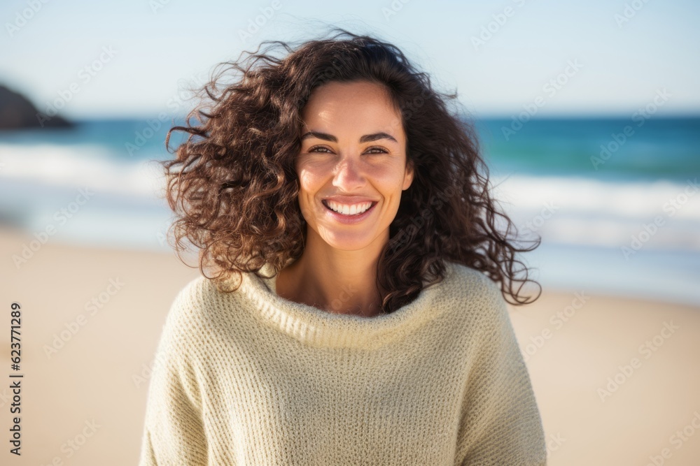 Portrait of smiling young woman standing on beach at the day time Portrait of smiling young woman standing on beach at the day time