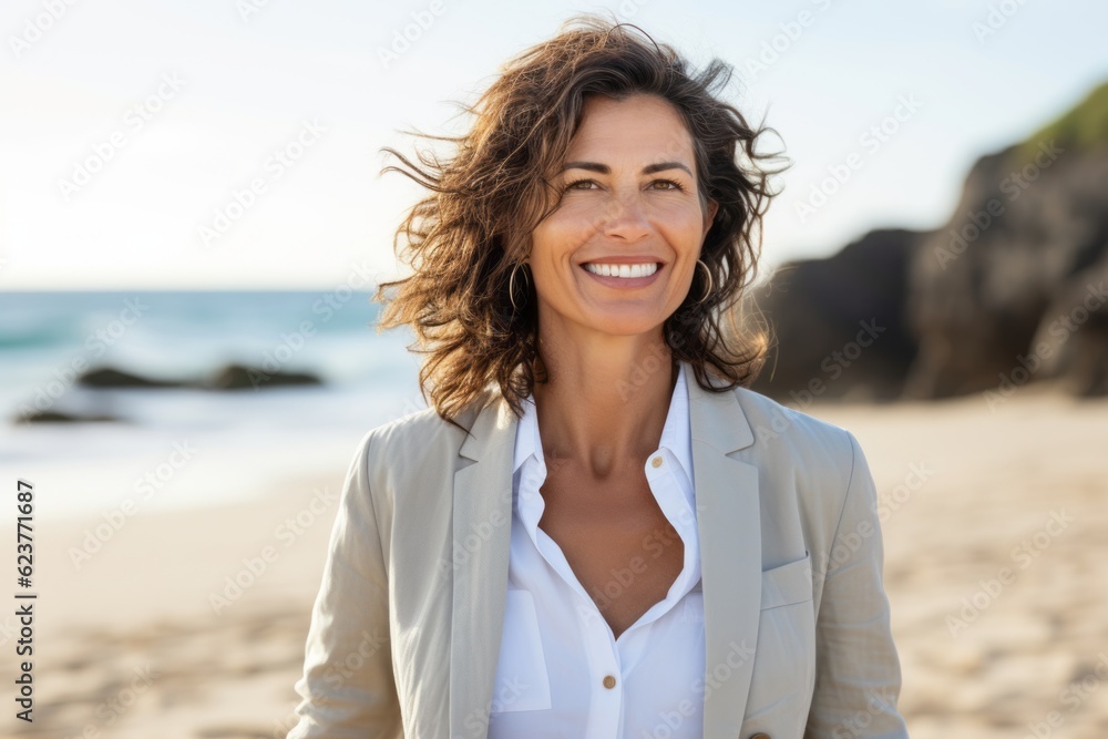 Portrait of smiling businesswoman standing on beach at the day time Portrait of smiling businesswoman standing on beach at the day time