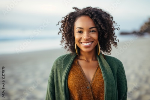 Portrait of smiling african american woman standing on the beach