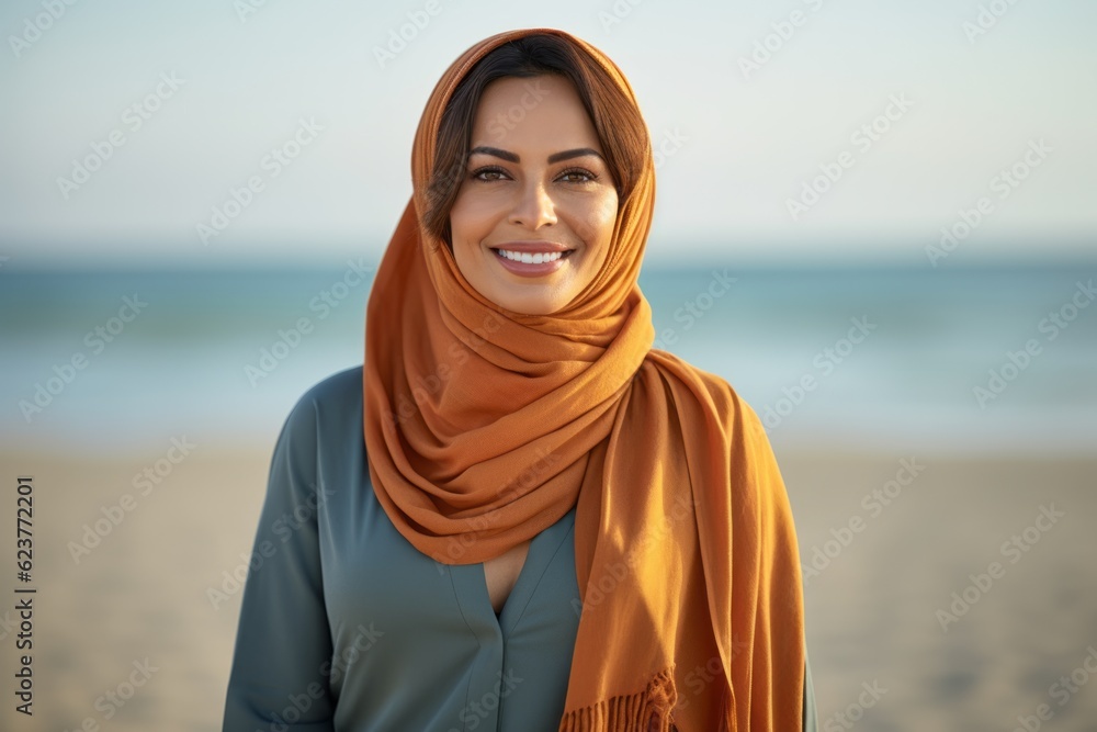 Beautiful young woman with scarf on beach, focus on her face Beautiful young woman with scarf on beach, focus on her face