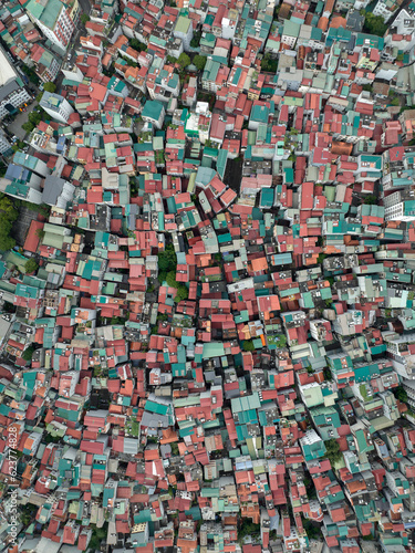 Aerial birds eye view of neighborhood in Hanoi city, Vietnam. Top down drone photo of densely packed buildings in the Vietnamese capital city. 
