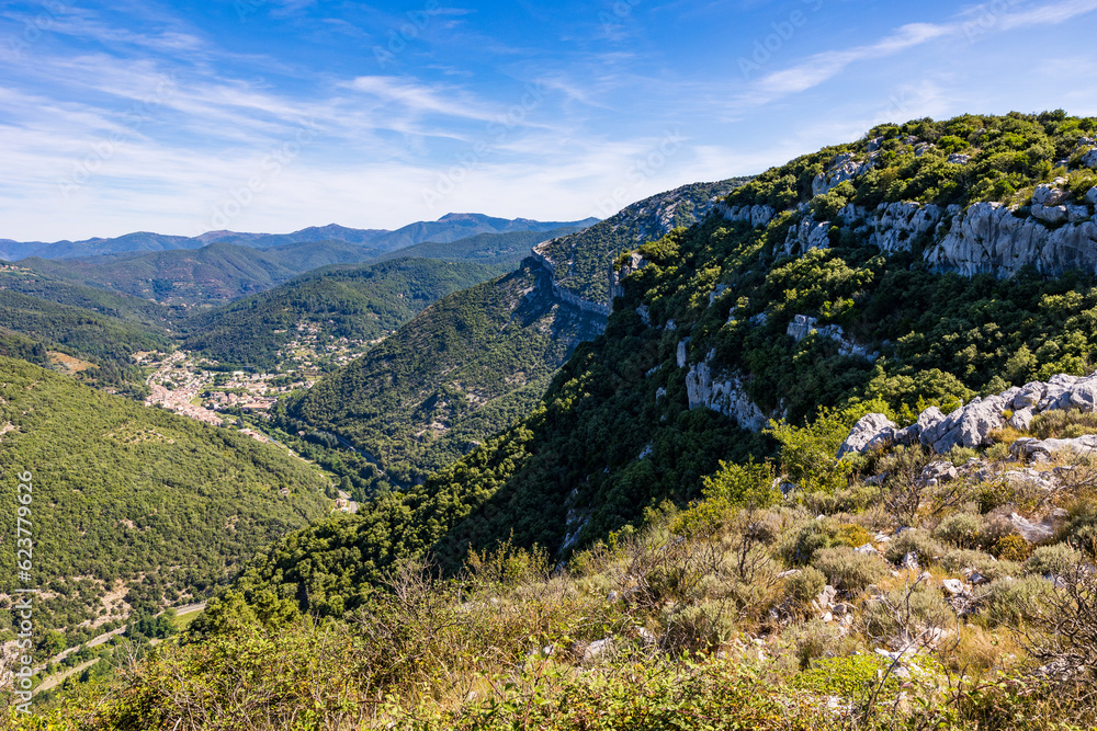 Village de Sumène en fond de vallée, au sud des Cévennes, dominées par les falaises et la forêt de la Réserve naturelle régionale de Combe Chaude et le sommet du Ranc de Banas