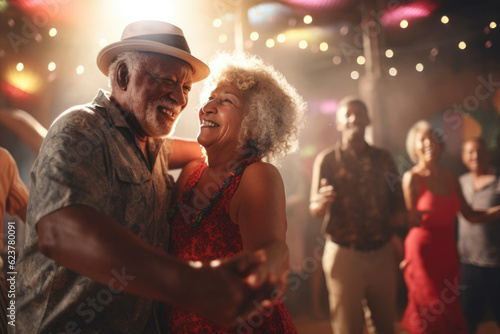 Happy senior african american couple dancing in disco club.