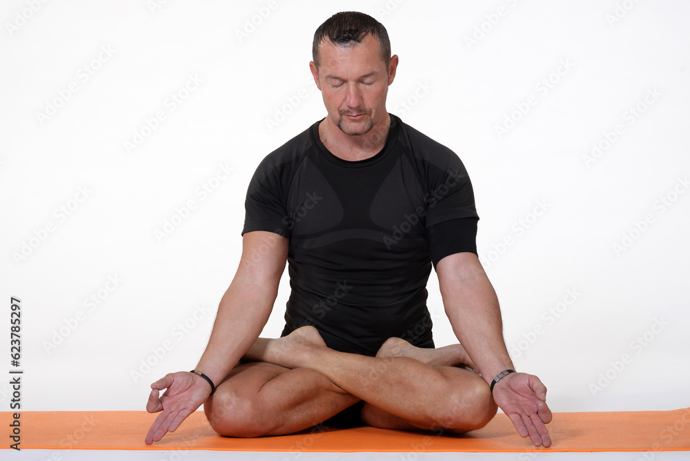 Man doing yoga in photo studio on isolated background. Man doing yoga in photo studio on isolated background.