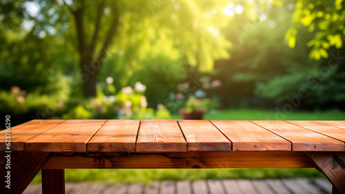 Empty sturdy wooden table, summer time, blurred backyard garden background.
