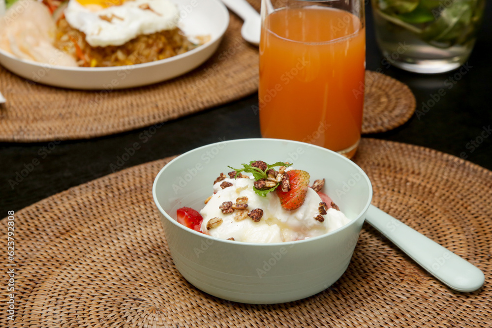 Greek yoghurt in a bowl with fruit slices and honey Greek yoghurt in a bowl with fruit slices and honey