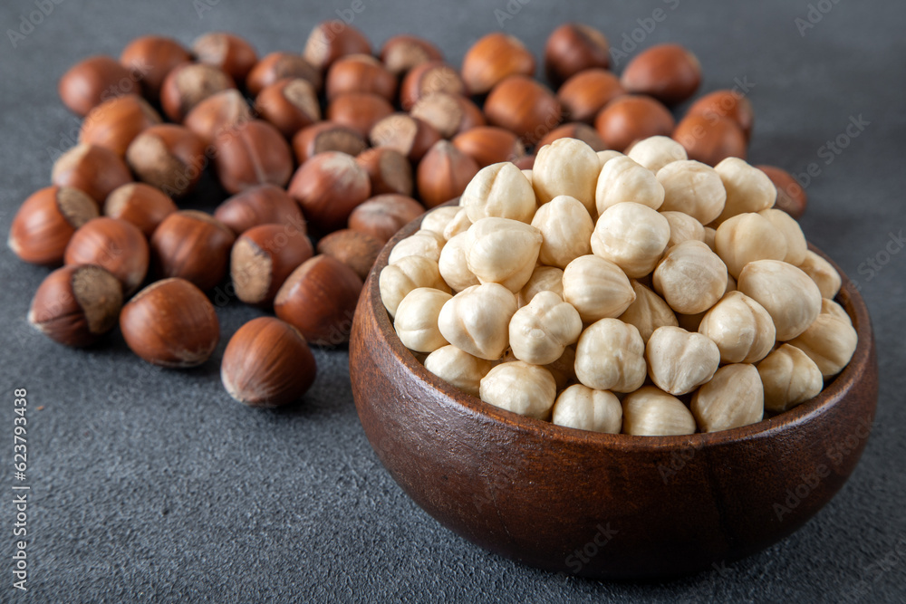 Heap of peeled and shelled hazelnuts on dark background Heap of peeled and shelled hazelnuts on dark background