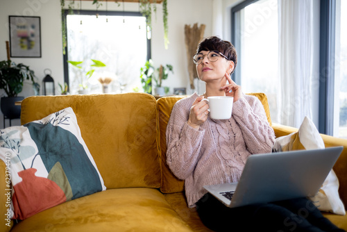 Woman with laptop at home focus and planning