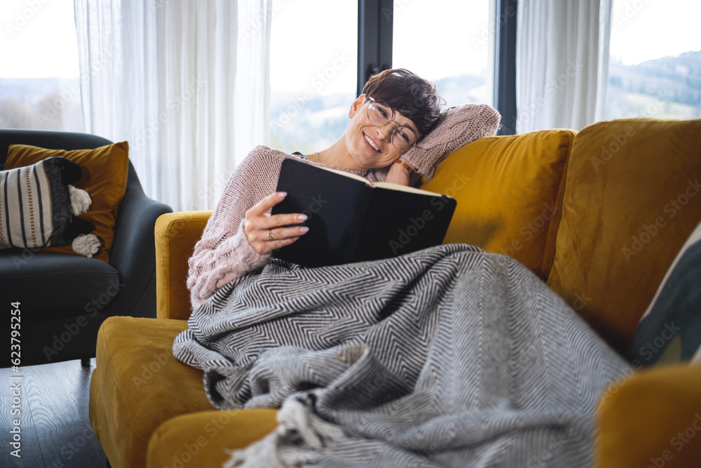 Relax at home with book on sofa Relax at home with book on sofa