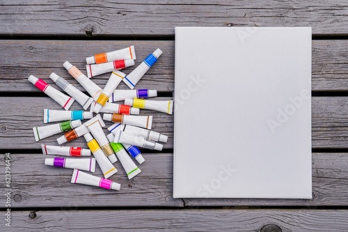 Wallpaper Mural Background blank white canvas with tubes of colored paints on wooden Torontodigital.ca