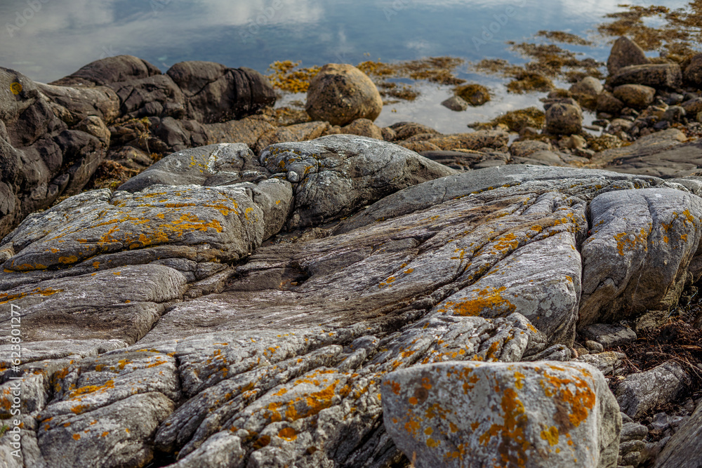 View of rocky Scandinavian seashore on sunny day View of rocky Scandinavian seashore on sunny day