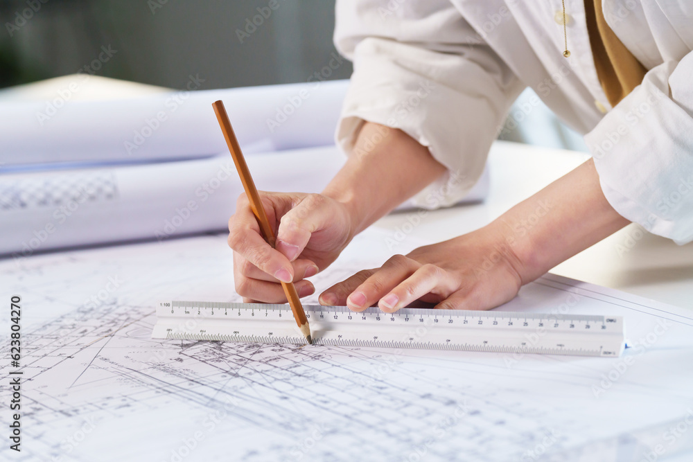 The designer drawings in the office The designer drawings in the office