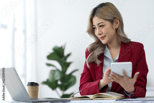 Businesswoman using calculator, laptop to check company finances income and budget Calculate monthly expenses, budget management, documents, loan documents, invoices Finance concept Accounting