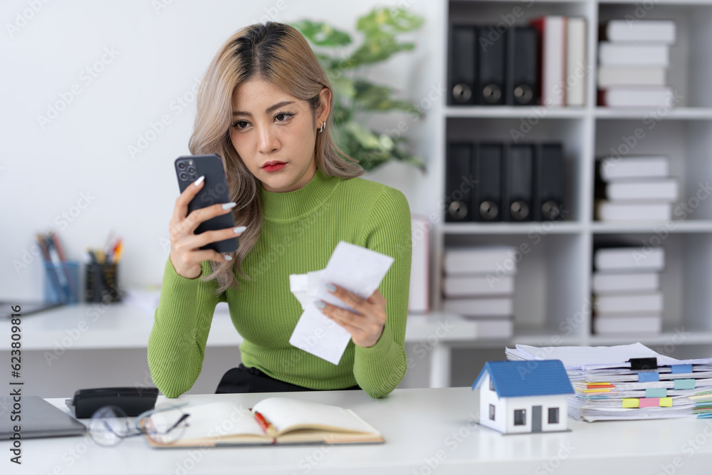 Asian businesswoman, real estate agent working, price calculation, house purchase contract Insurance or loan, home modeling, real estate consulting about mortgage loan offerings in the home office. Asian businesswoman, real estate agent working, price calculation, house purchase contract Insurance or loan, home modeling, real estate consulting about mortgage loan offerings in the home office.