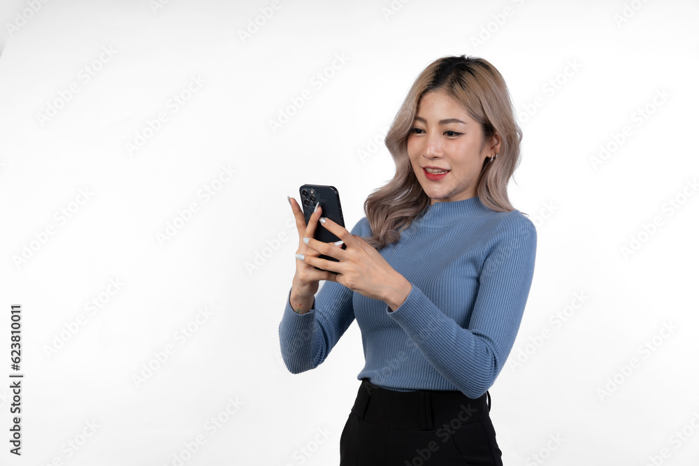 Portrait of confident Asian businesswoman Demonstrates motivation to work in business looking happy while using mobile phone to communicate online, isolated on white background. Portrait of confident Asian businesswoman Demonstrates motivation to work in business looking happy while using mobile phone to communicate online, isolated on white background.