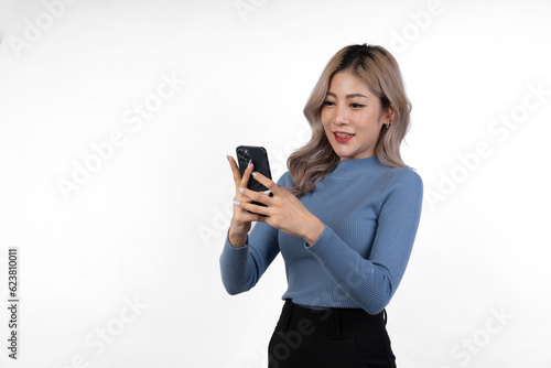 Portrait of confident Asian businesswoman Demonstrates motivation to work in business looking happy while using mobile phone to communicate online, isolated on white background.