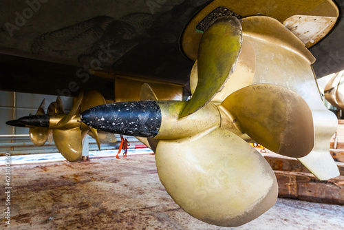 Bronze propellers on an expensive yacht. Three azimuthal thrusters at the stern of the yacht. Propellers with double row of blades.