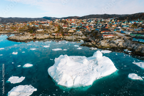 The arctic town of Ilulissat in Greenland by the ocean coast photo