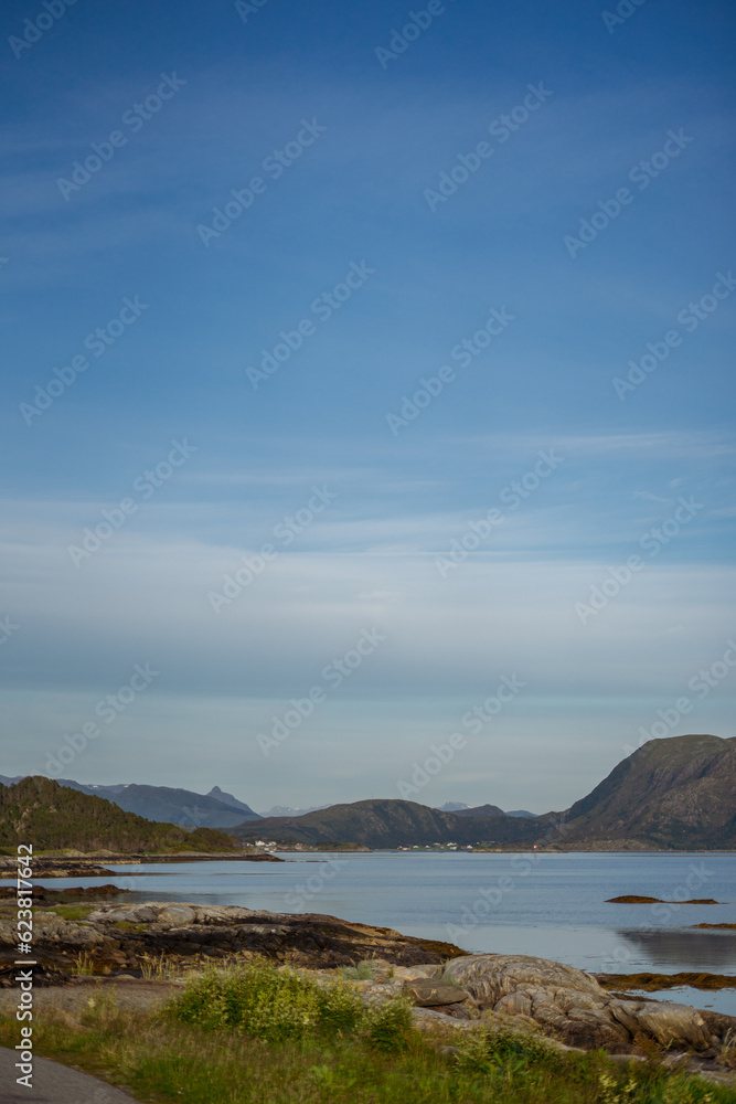 vertical view of sea bay lake surrounded by mountains sunny day