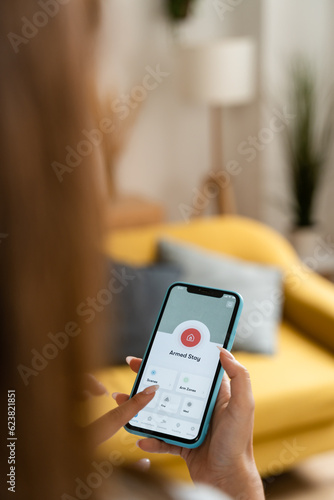 Woman holding a smart home screen display.