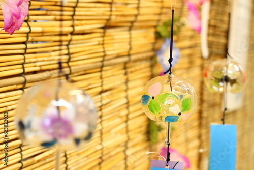 Colorful Japanese wind chimes with bamboo blind background