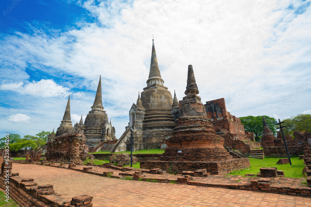 Fototapeta premium Three pagodas in an ancient Buddhist temple called Wat Prasrisanpetch in Ayutthaya historical park under noon sun light, public domain