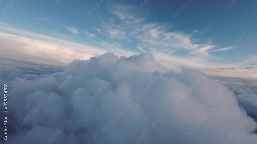 Flight between the clouds, first-person view of the aircraft during the flight at sunset. Planning between cloud clusters. aerial view Flight between the clouds, first-person view of the aircraft during the flight at sunset. Planning between cloud clusters. aerial view