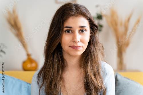 Young woman with long brown hair and a captivating gaze.