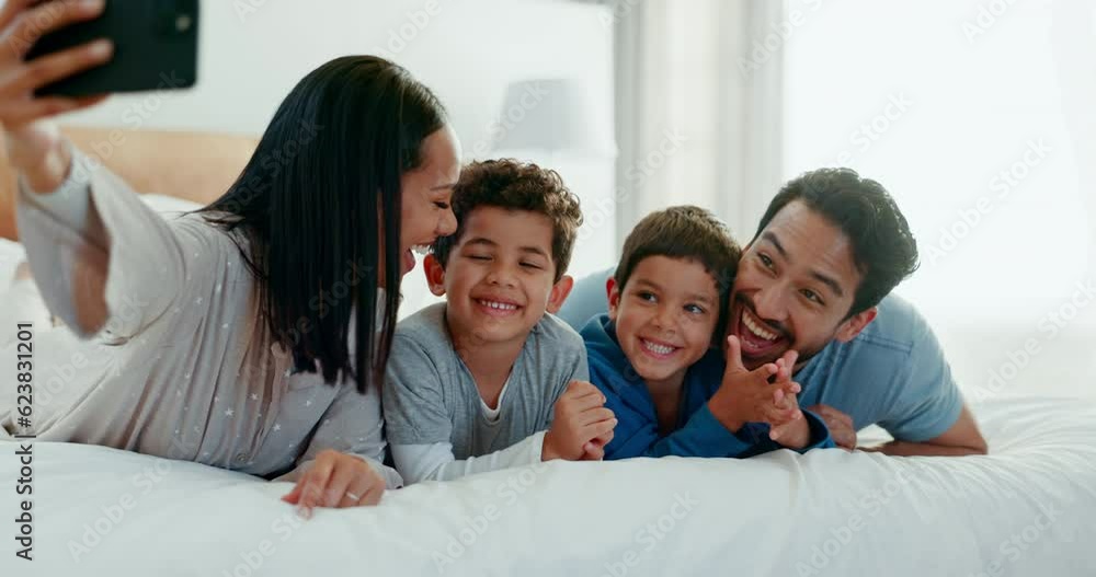 Family selfie, laughing and in a home bedroom for a memory, happy and comedy together. Smile, love and a young mother, father and children taking a photo on a bed in the morning for care and fun Family selfie, laughing and in a home bedroom for a memory, happy and comedy together. Smile, love and a young mother, father and children taking a photo on a bed in the morning for care and fun