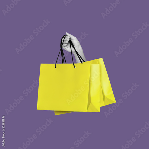 Antique female statue's hand holding yellow shopping paper bag isolated on violet color background.  3d trendy collage in magazine style. Contemporary art. Modern creative design photo