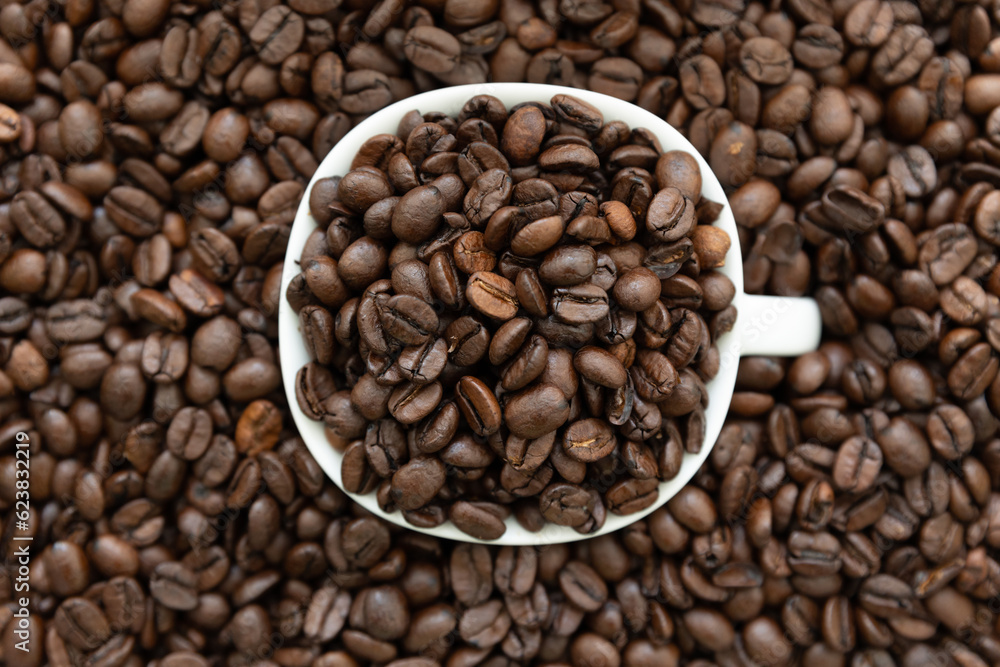 coffee beans in a cup on a coffee bean brown backgroun coffee beans in a cup on a coffee bean brown backgroun