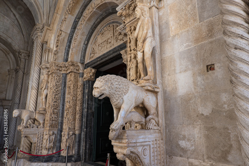 Marble lions on the entry porch of the Trogir Cathedral photo
