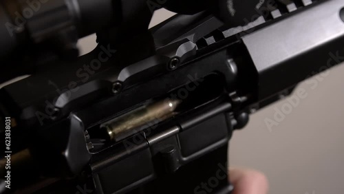 AR-15 rifle. Installing the magazine and sending the cartridge into the chamber of the rifle photo