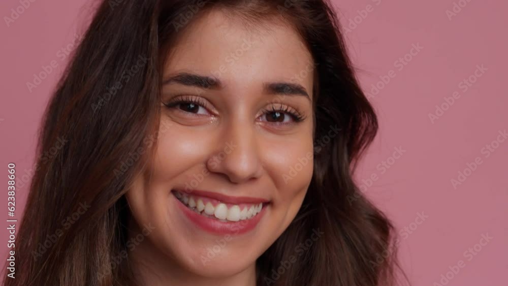 Smiling brunette woman in studio shot. Smiling brunette woman in studio shot.