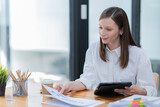 Portrait of beautiful smiling young brunette businesswoman sitting at in the office modern work station