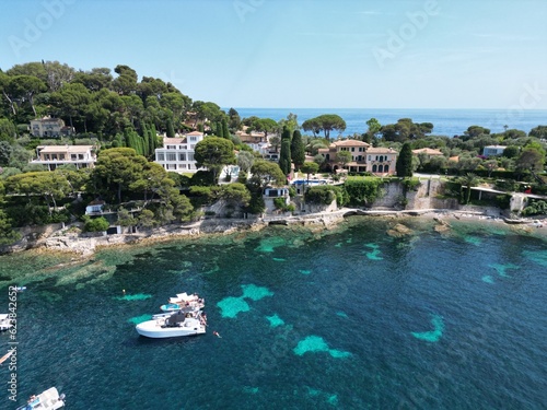 People swimng off boats moored Cap Ferrat France drone,aerial .
