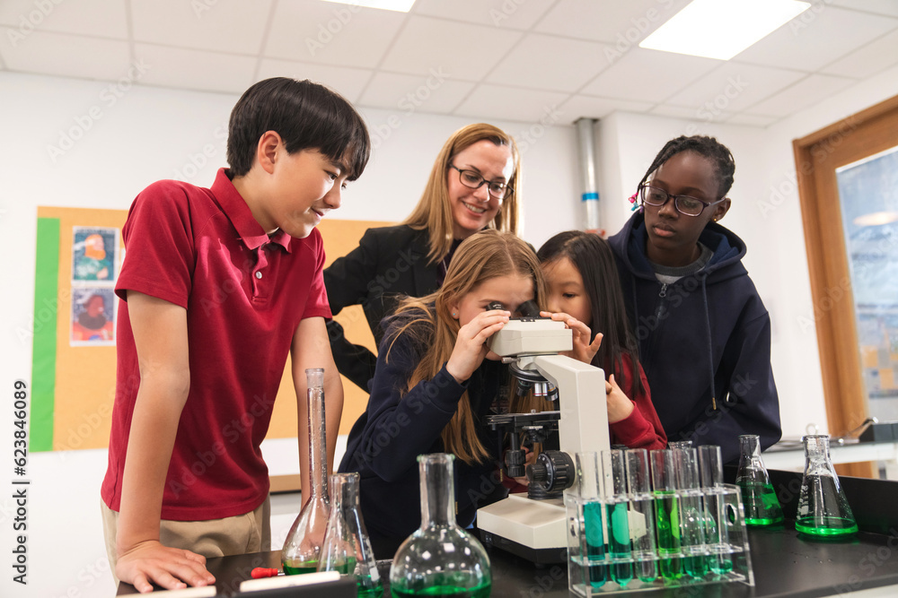The teacher counselling pupils do science experiments The teacher counselling pupils do science experiments