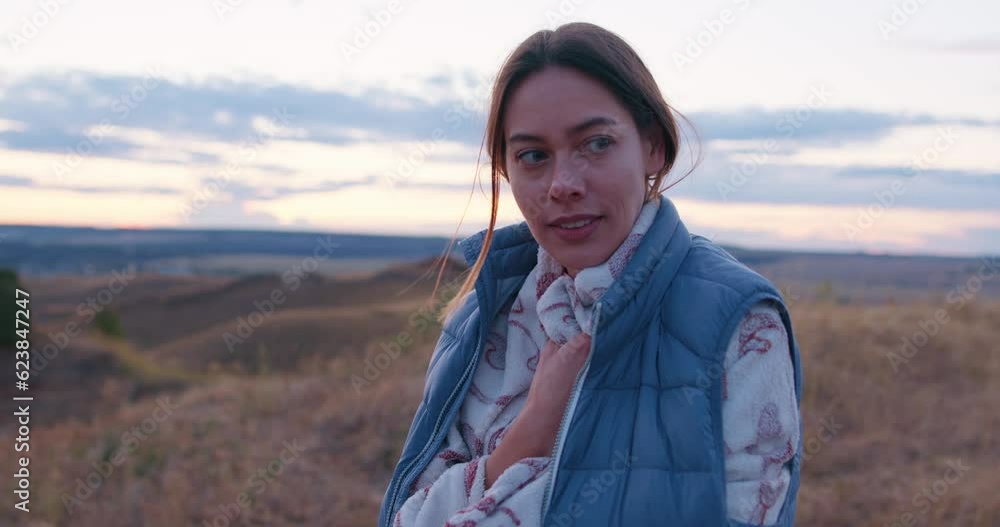 beautiful brown-haired female tourist feels cold suffering from uncomfortable low temperature trying to keep warm wrapped by clothes, blanket, looking at camera slow motion beautiful brown-haired female tourist feels cold suffering from uncomfortable low temperature trying to keep warm wrapped by clothes, blanket, looking at camera slow motion