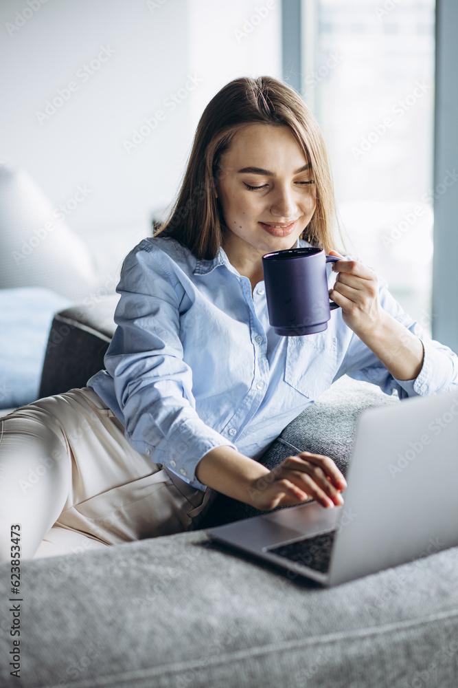 Business woman working on laptop and drinking coffee Business woman working on laptop and drinking coffee