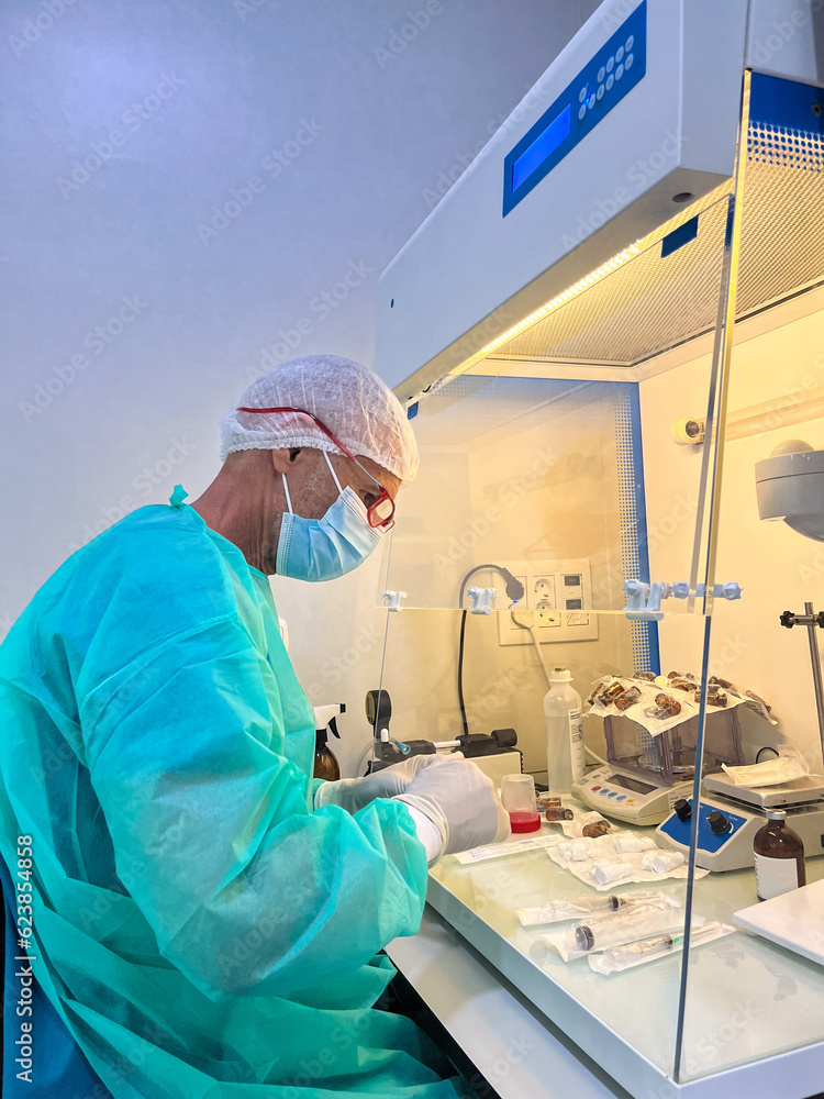 Elder man with surgeon gown working in a laboratory Elder man with surgeon gown working in a laboratory