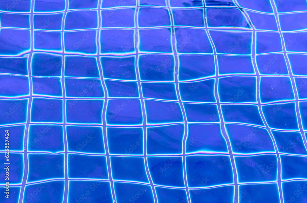 Abstract texture, background of blue swimming pool with transparent rippled water